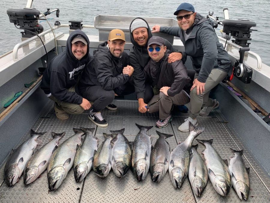 Group of anglers with salmon catch on a boat in Ucluelet